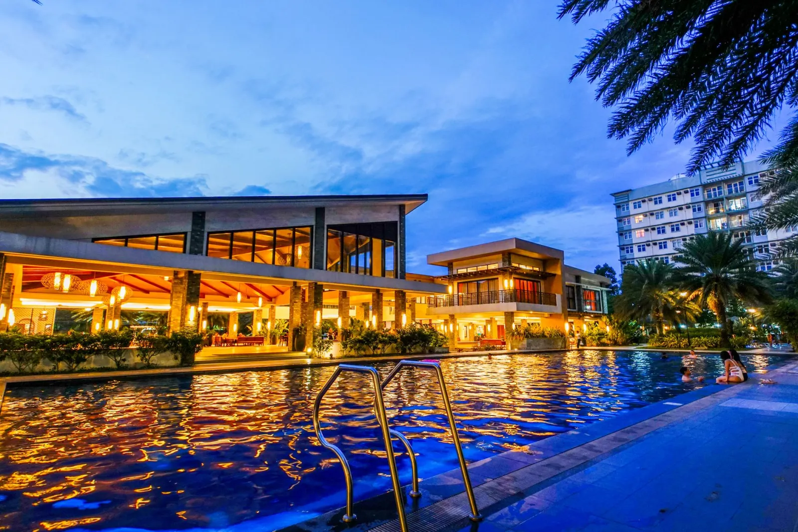 Een adembenemend uitzicht bij schemering op een luxe resort met een schitterend zwembad en moderne architectuur.